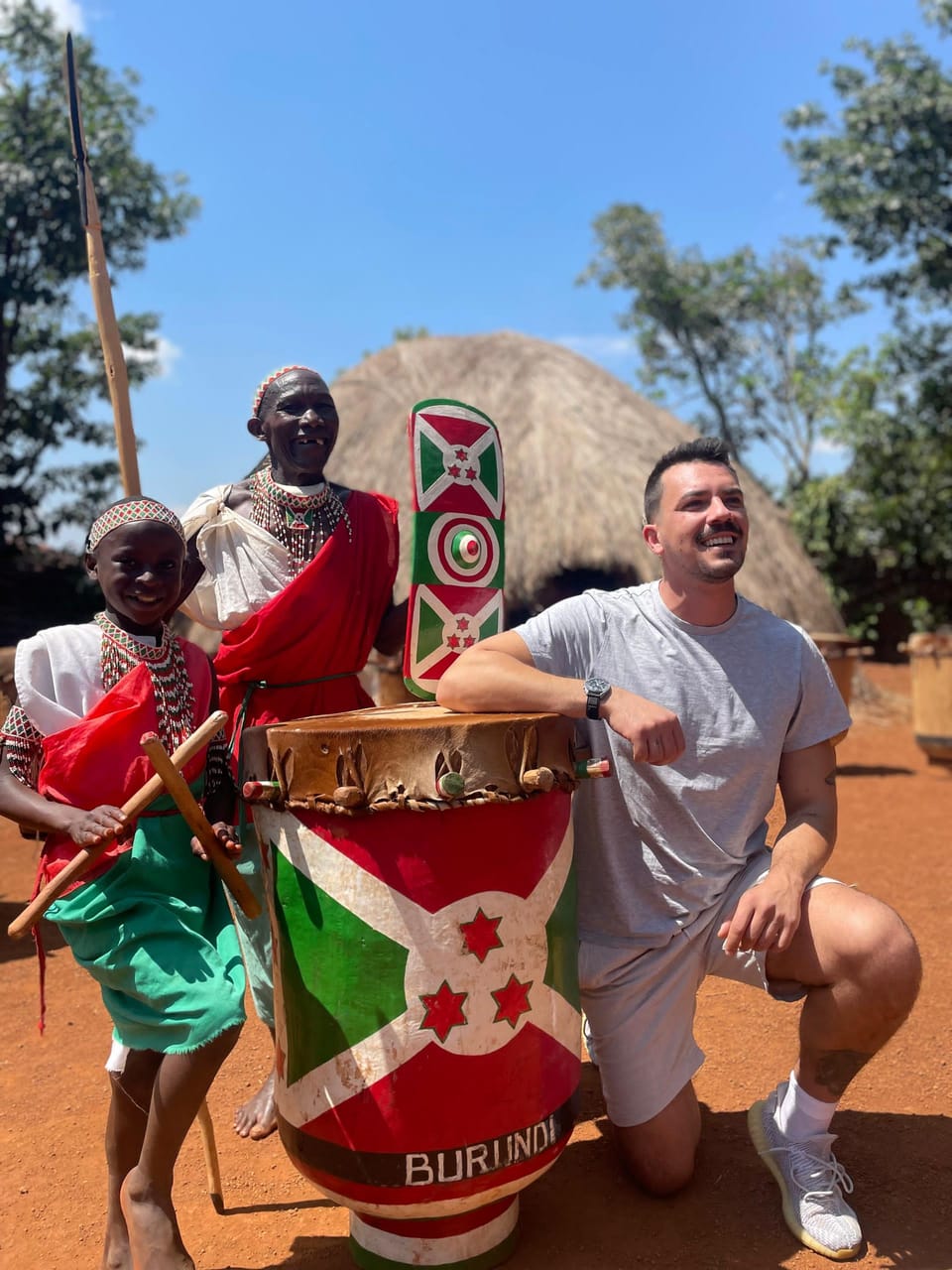 Guest playing the traditional drums with performers in Burundi